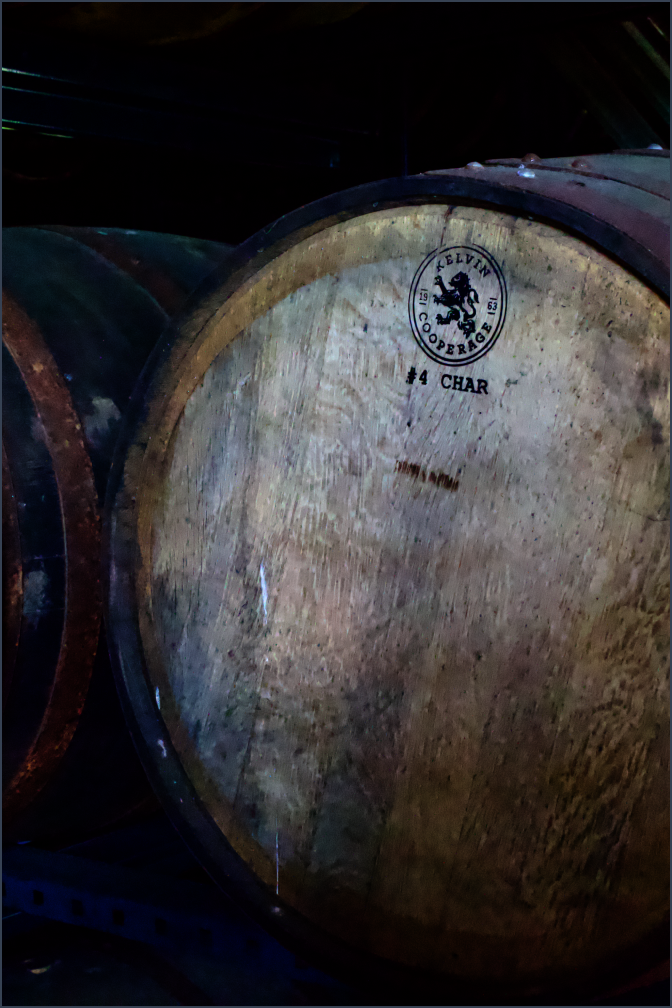 Close-up of an American oak barrel end stamped with "#4 Char," essential for crafting the unique flavor of Luminance single barrel bourbon.